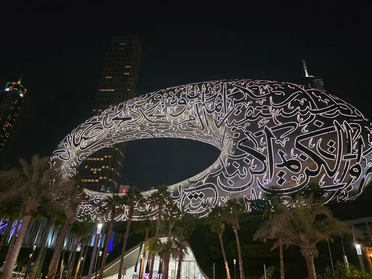 The Museum of the Future in Dubai at night, its calligraphy facade lit up