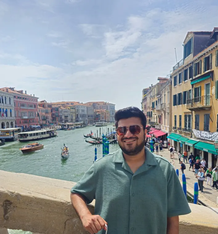 Sandeep smiling by the Grand Canal in Venice