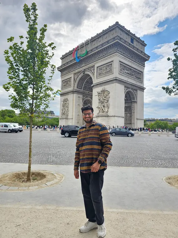 Sandeep standing in front of the Arc de Triomphe